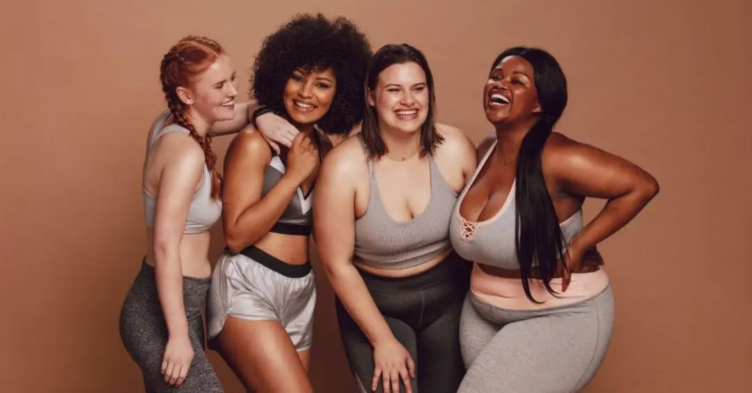 A group of smiling models wearing activewear.